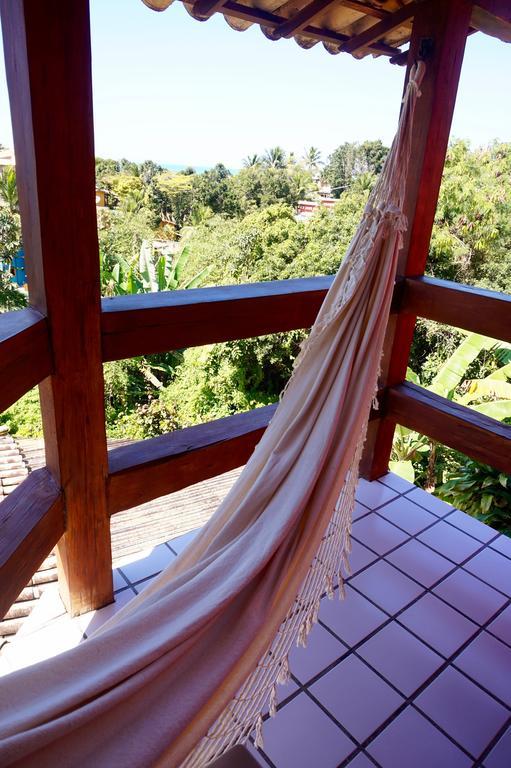 Novos Baianos Hostel E Pousada Porto Seguro Exteriör bild A hammock hanging from a balcony